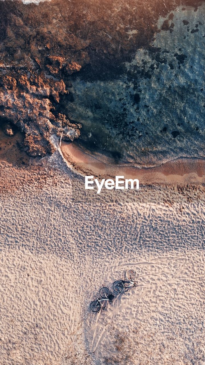 Aerial view of a beach and bicycles