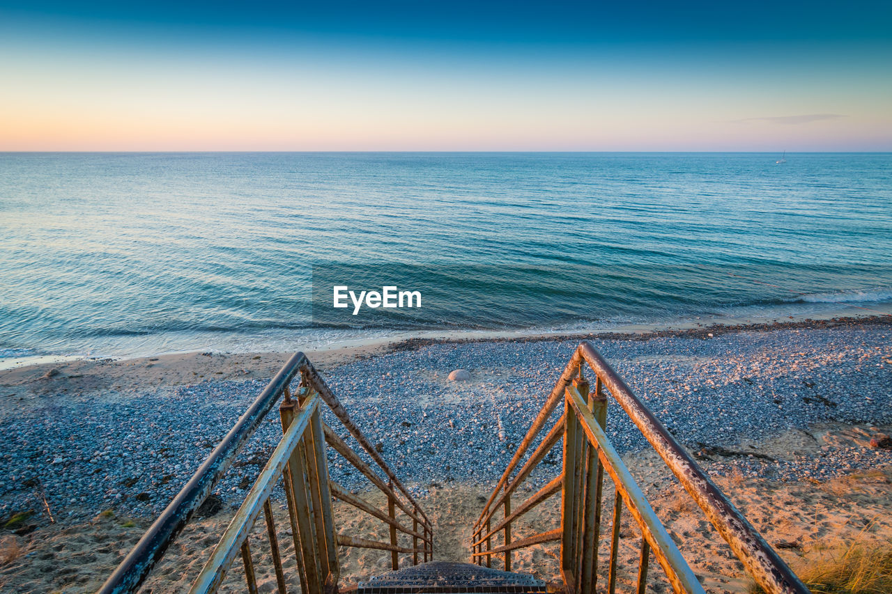 High angle view of sea against clear sky during sunset