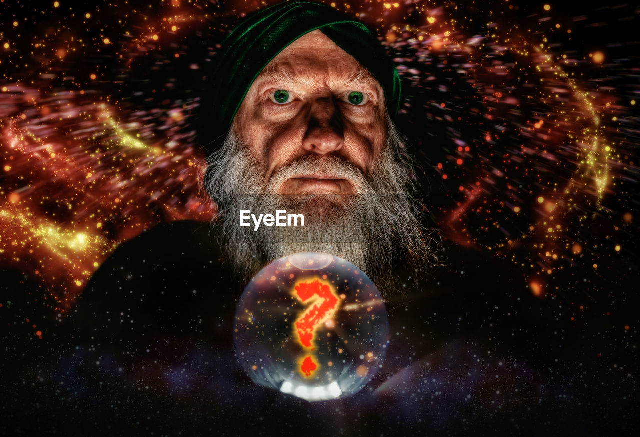 Digital composite image of man with crystal ball