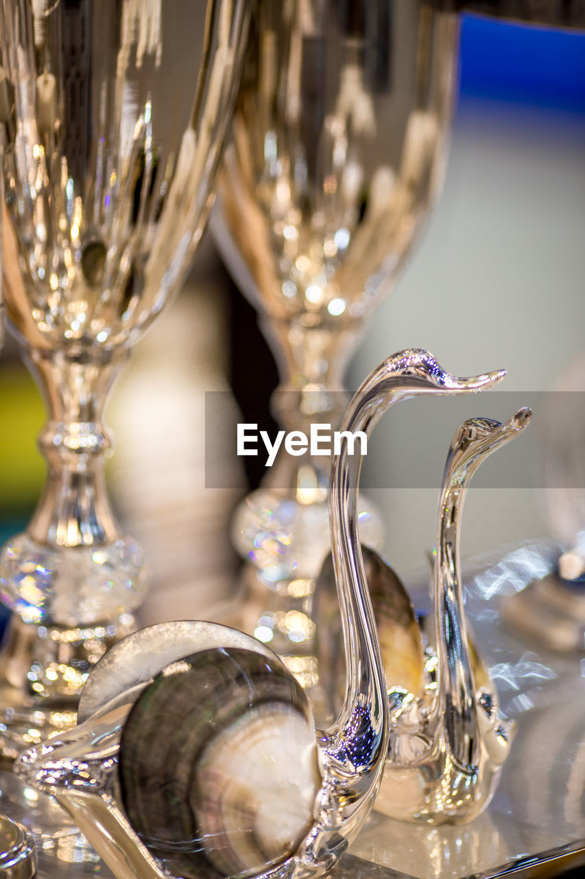 CLOSE-UP OF WINE GLASSES ON GLASS TABLE