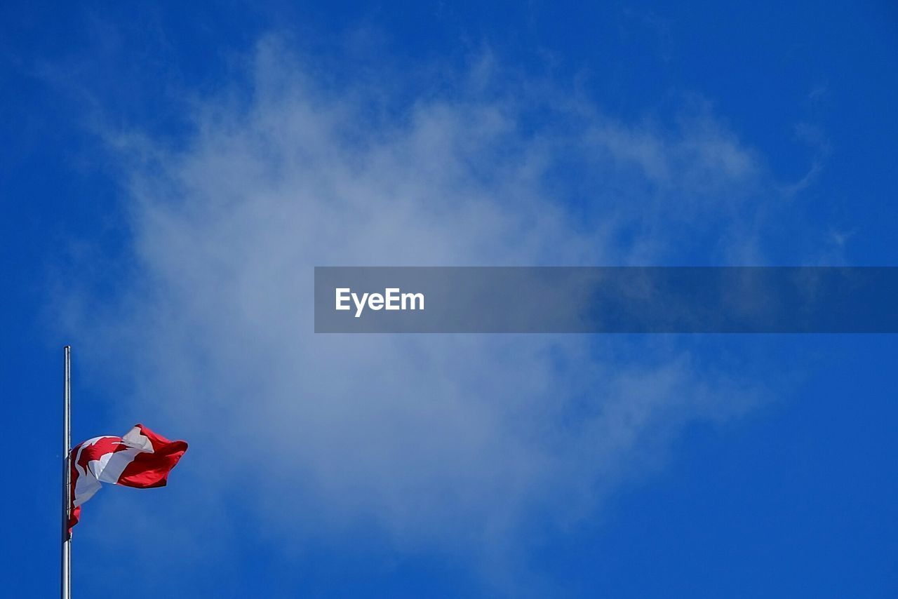 Canadian flag against blue sky