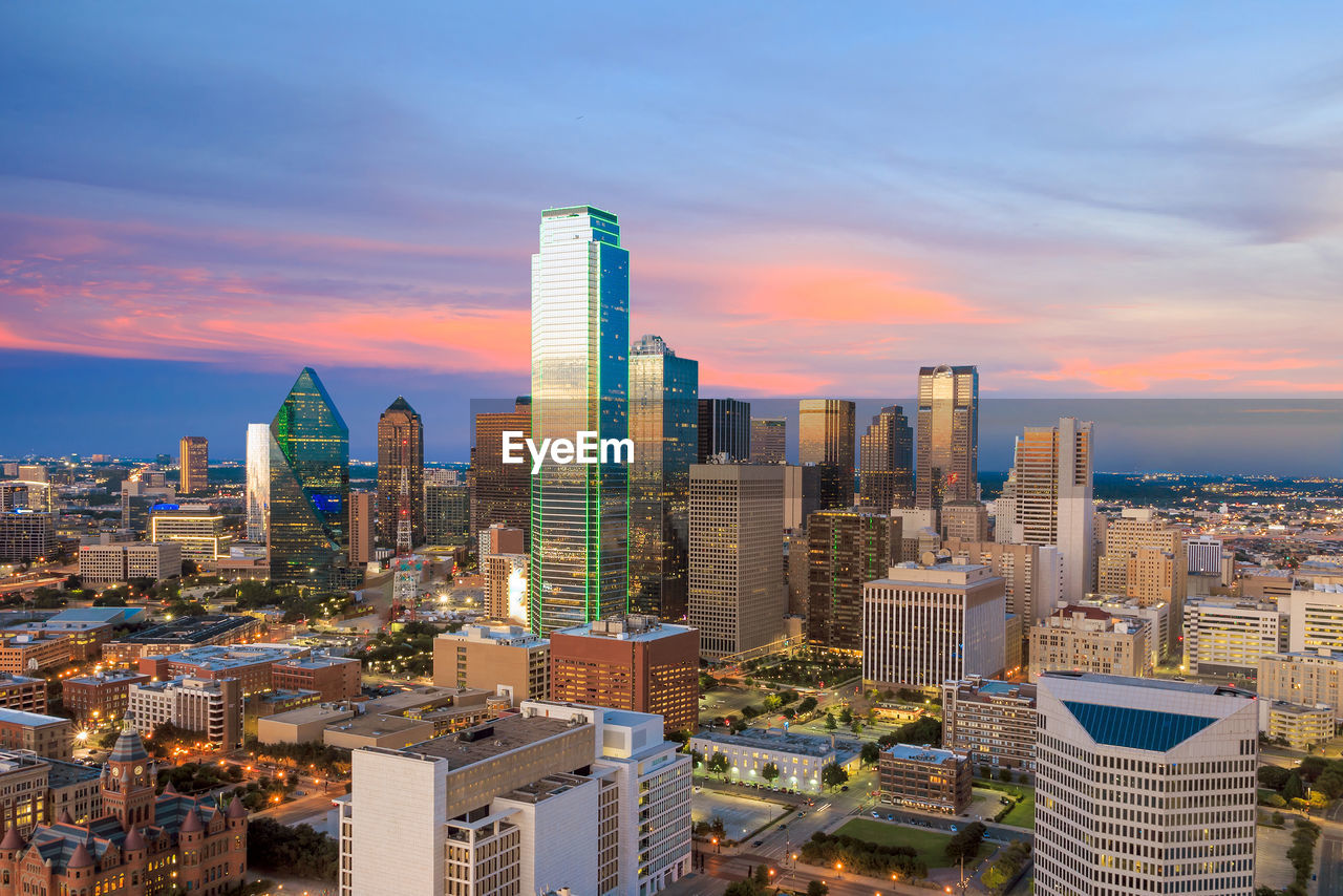 high angle view of buildings in city against sky during sunset