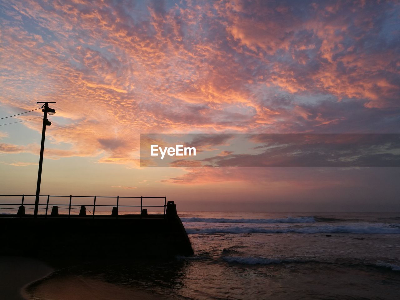 Scenic view of sea against dramatic sky