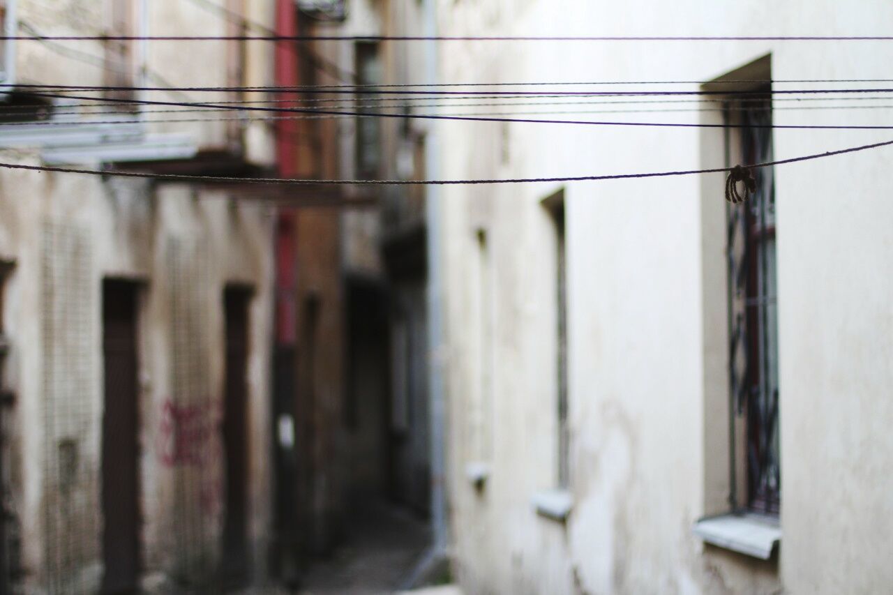 Strings in narrow alley amidst buildings