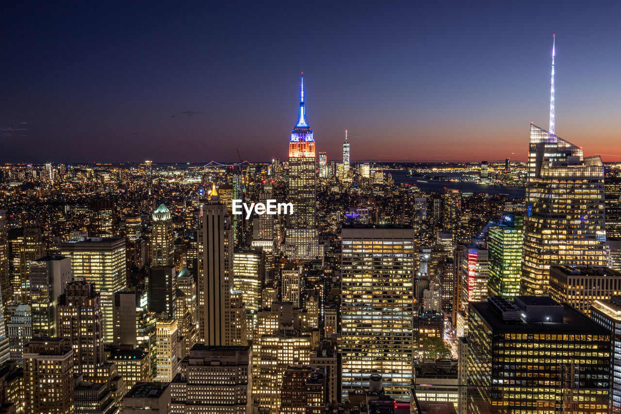 Illuminated buildings in city at night