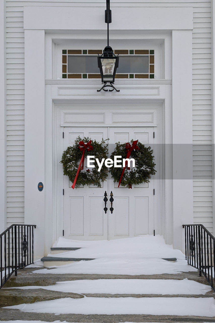 Wreaths on the doors of a white church