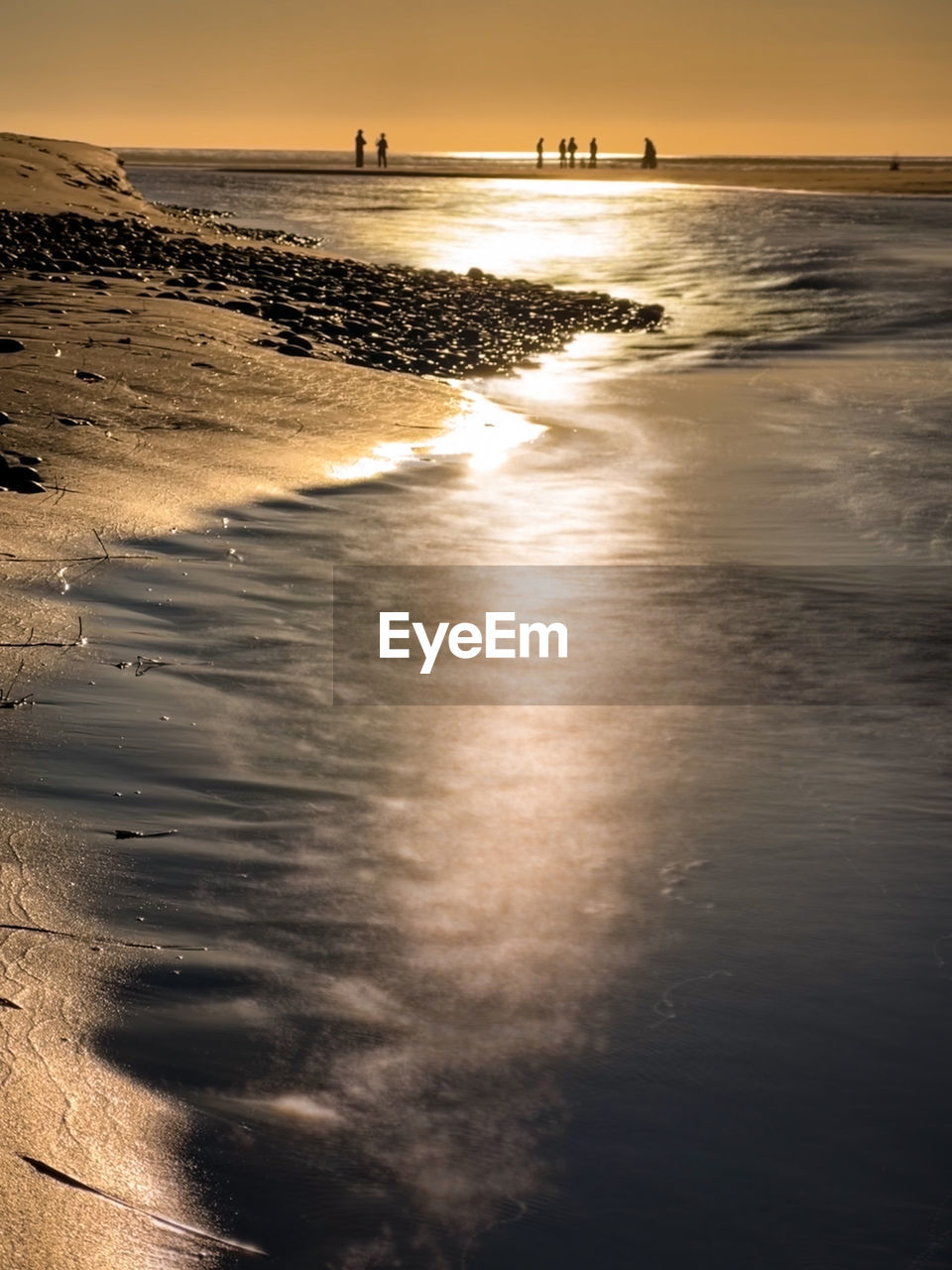 scenic view of beach against sky during sunset