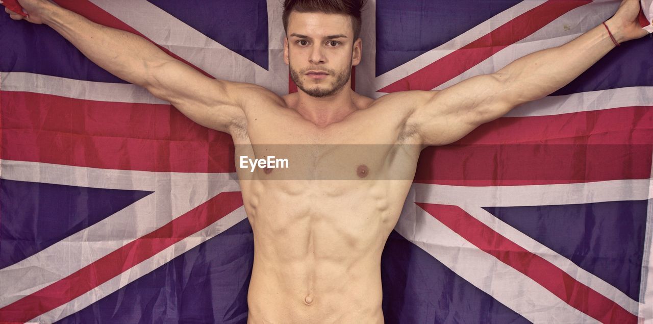 Portrait of shirtless muscular man with australian flag