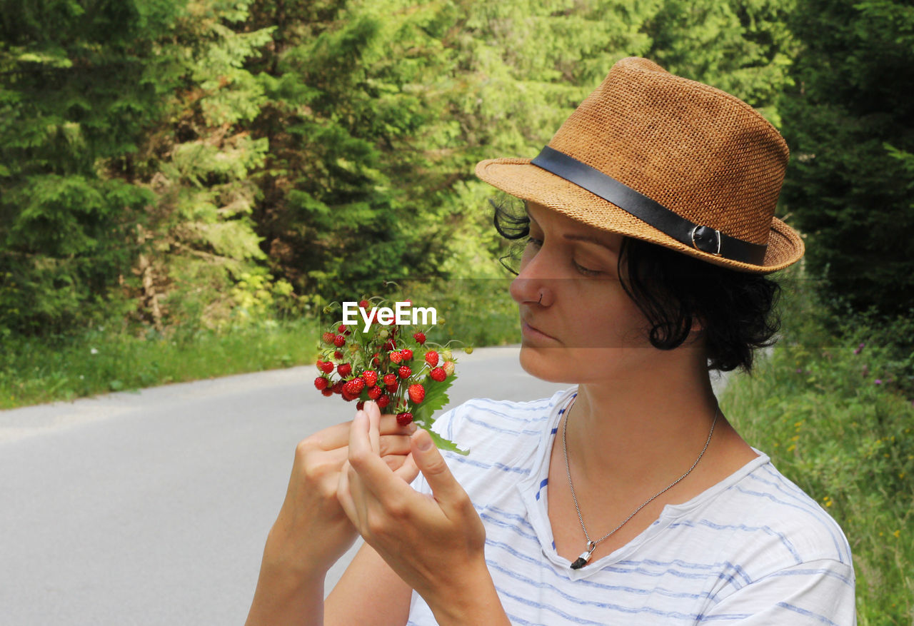 Close-up of woman looking at strawberries