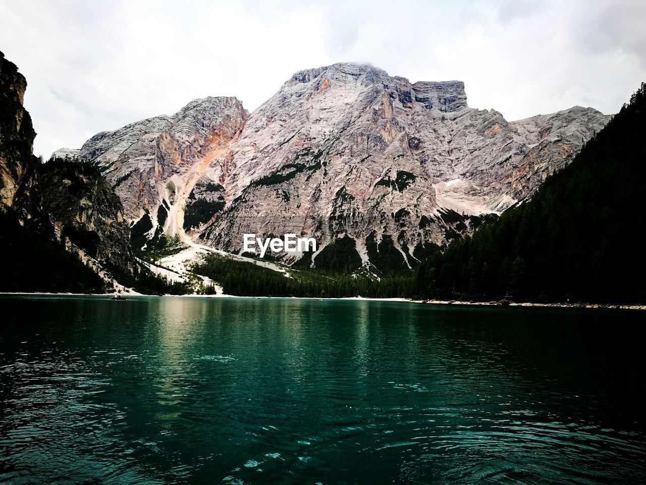 Scenic view of lake with mountain range in background