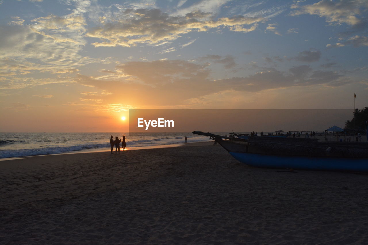 Scenic view of beach against sky during sunset