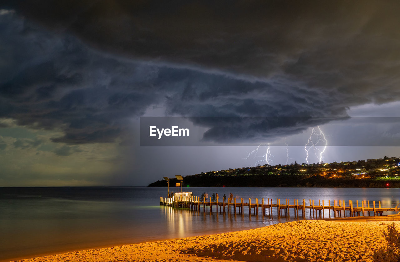Lightning storm over port phillip bay, victoria with a lightning strikes on the hill 