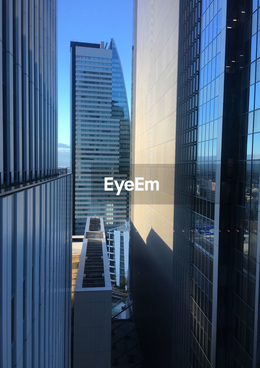 MODERN BUILDINGS IN CITY AGAINST SKY