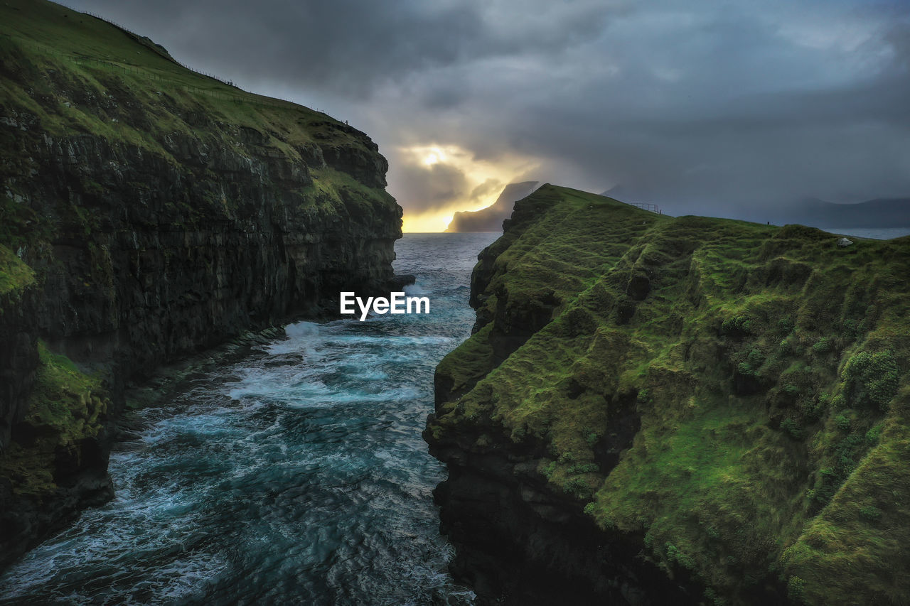 Rock formation amidst sea against sky