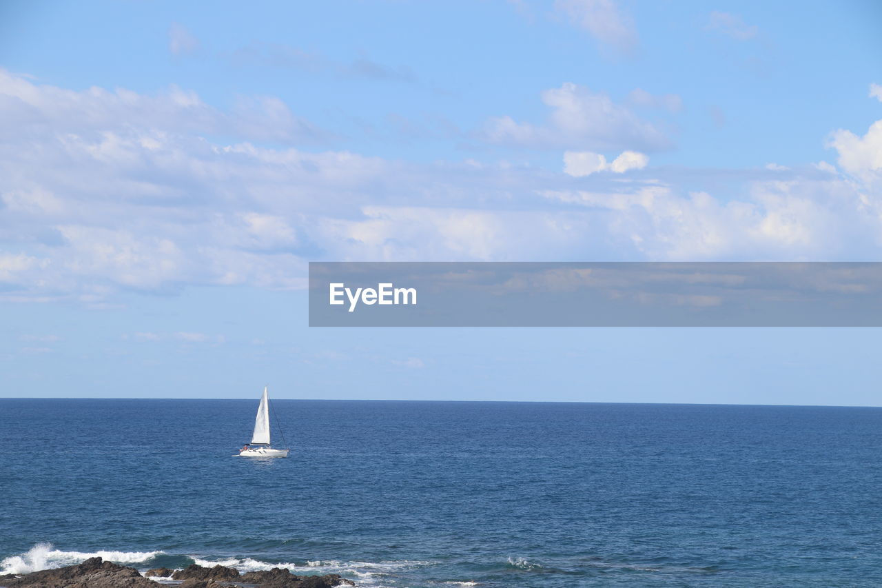 sea, water, sky, horizon over water, horizon, nautical vessel, sailboat, sailing, cloud, transportation, ocean, beauty in nature, ship, scenics - nature, mode of transportation, nature, vehicle, tranquility, tranquil scene, coast, day, sailing ship, boat, travel, shore, no people, idyllic, blue, outdoors, bay, yacht, beach, non-urban scene, watercraft, body of water, tower