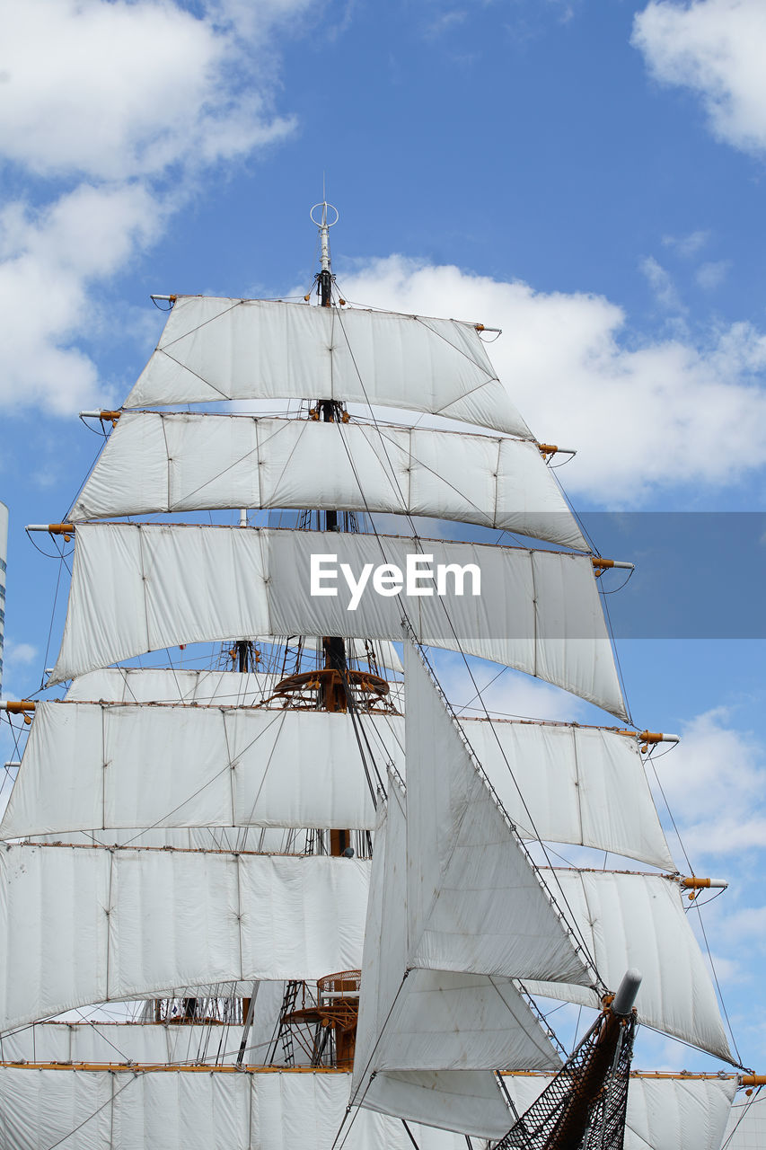 Low angle view of sailboat on sea against sky