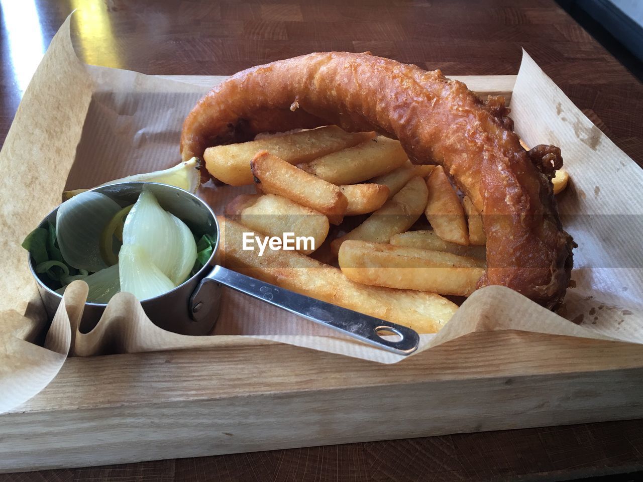 High angle view of french fries with sausage on tray