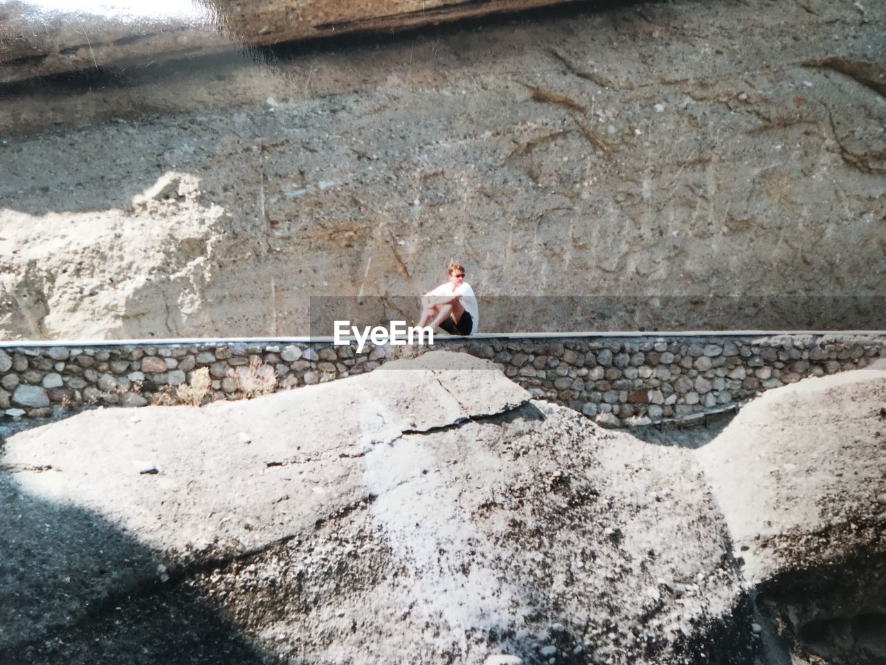 High angle view of man standing on rock météore greece 2000 year