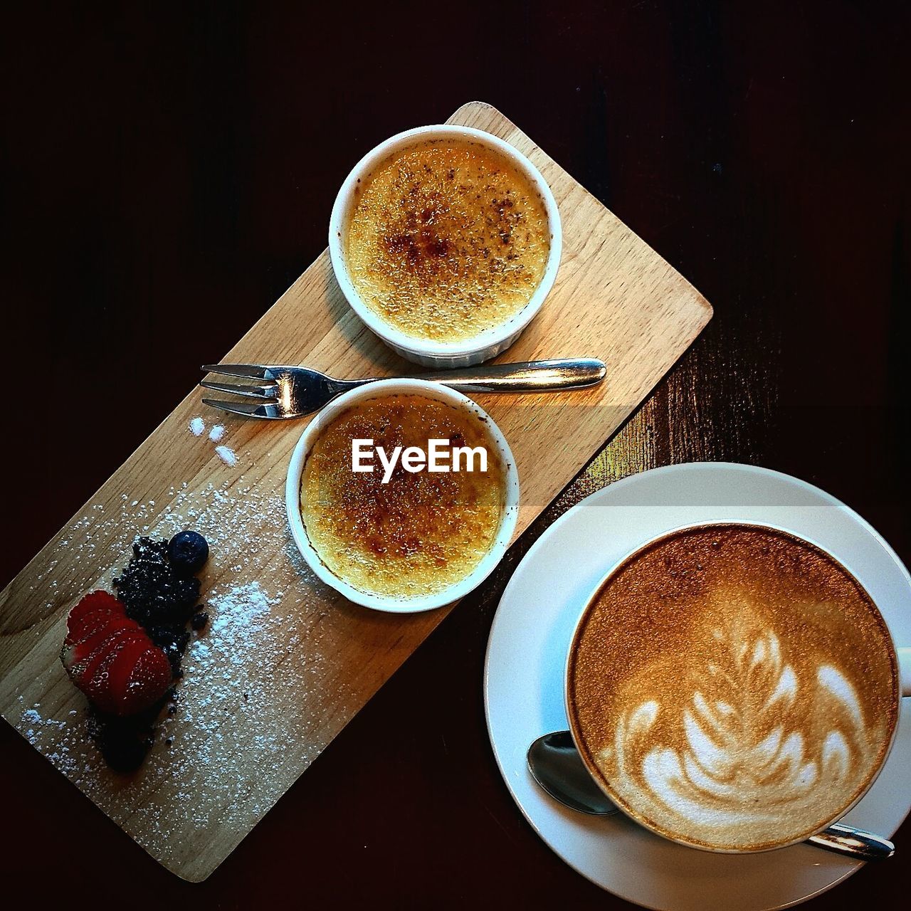 CUP OF COFFEE AND CUPS ON TABLE