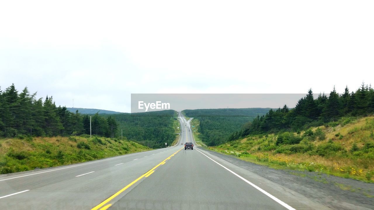 VIEW OF ROAD PASSING THROUGH LANDSCAPE