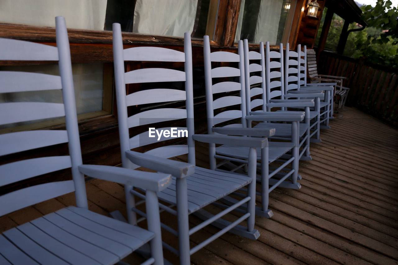 EMPTY CHAIRS AND TABLES AT RESTAURANT