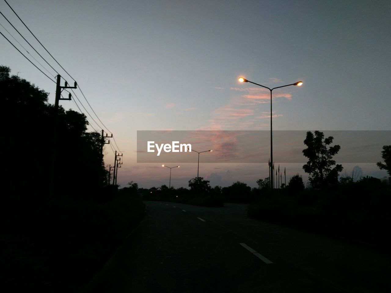 STREET LIGHTS AGAINST SKY AT SUNSET