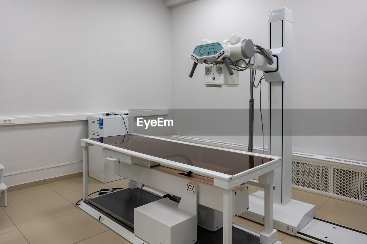 X-ray machine. an x-ray room with a scanning machine and an empty bed. scanning of the chest