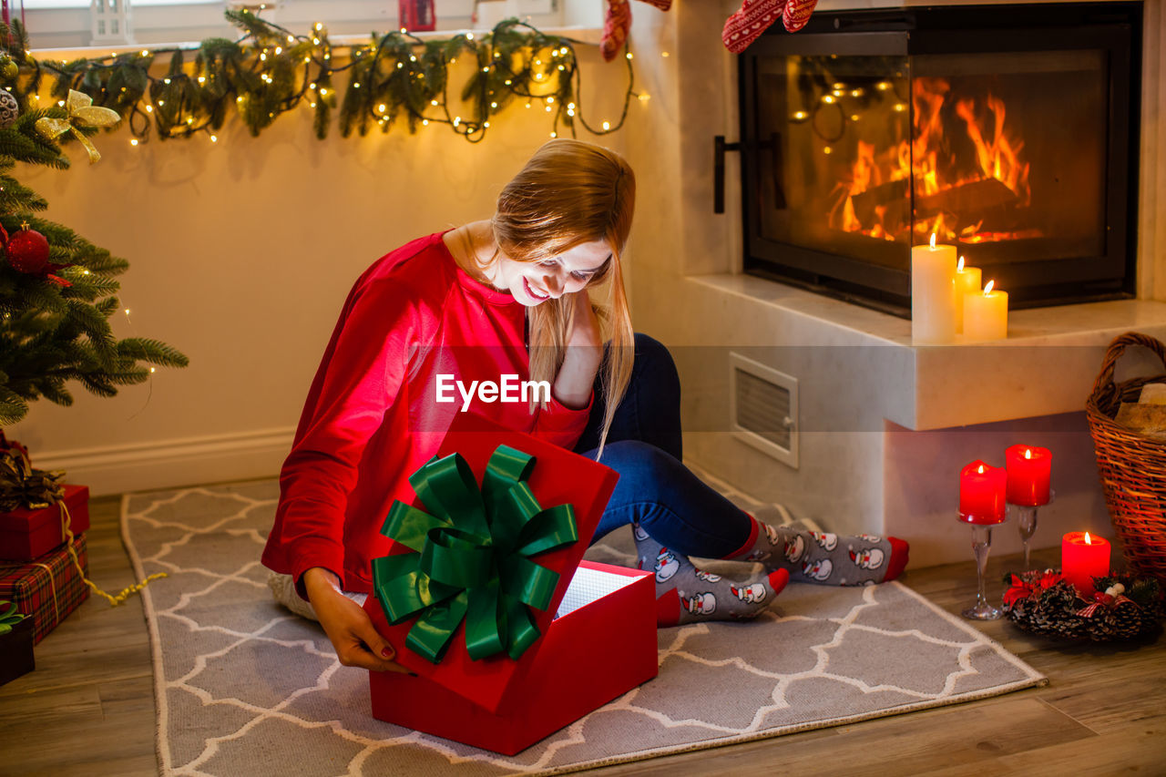 midsection of woman holding illuminated christmas tree