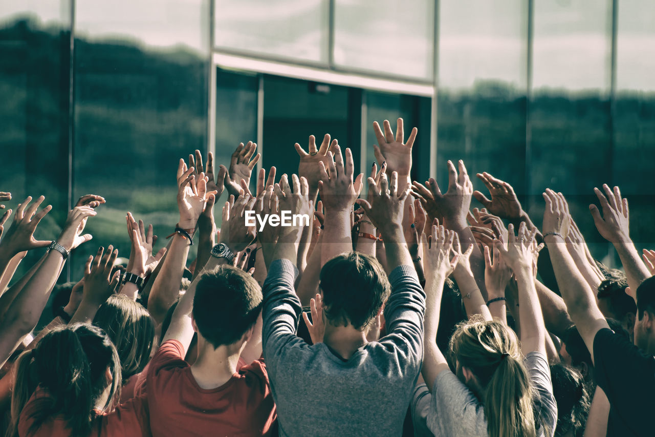 People standing with arms raised