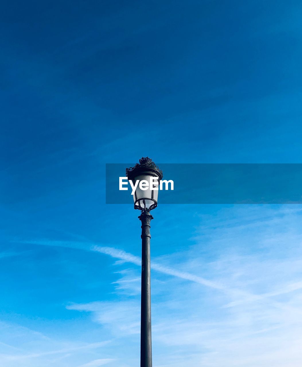 Low angle view of street light against blue sky