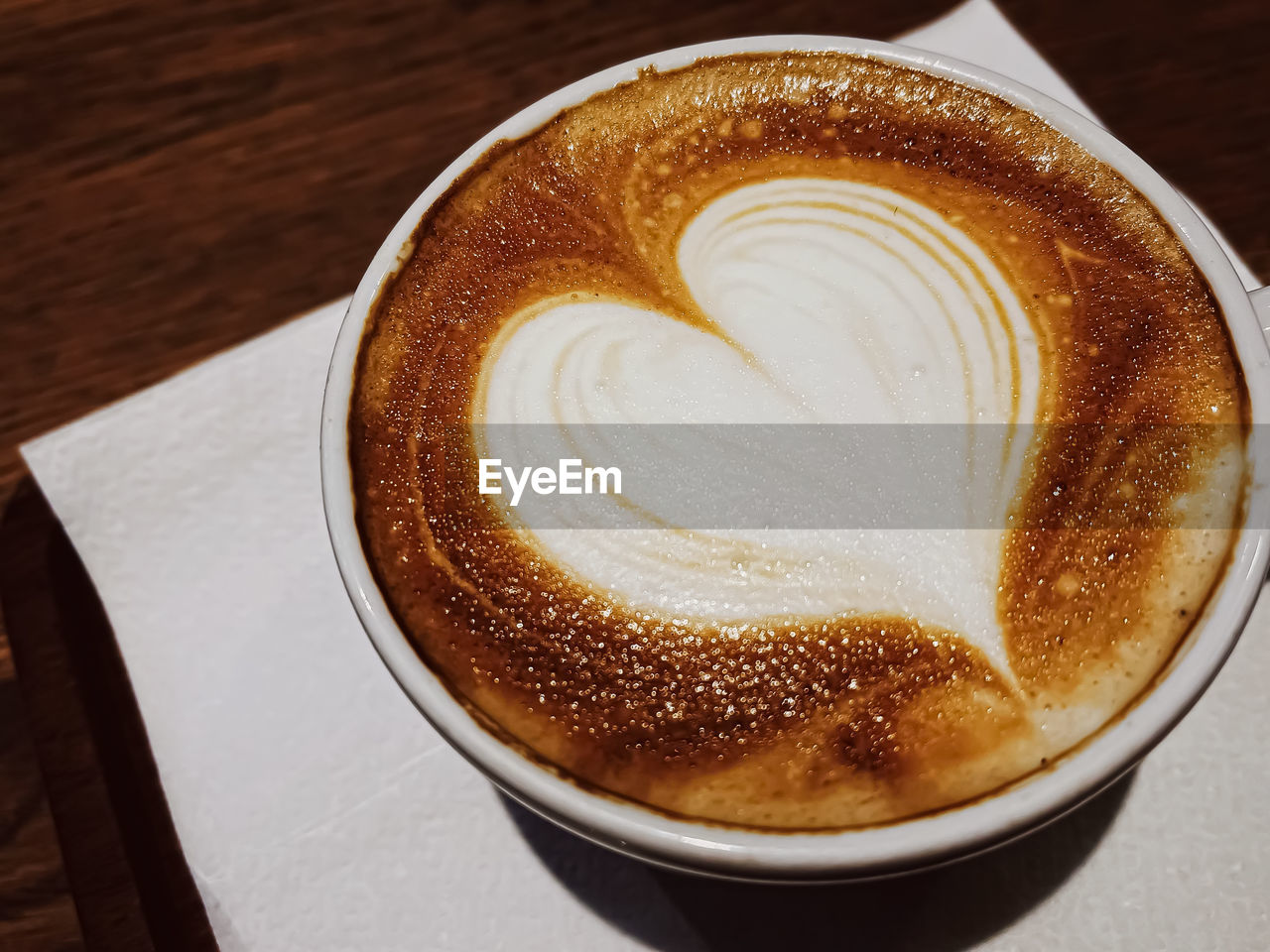 CLOSE-UP OF CAPPUCCINO ON TABLE