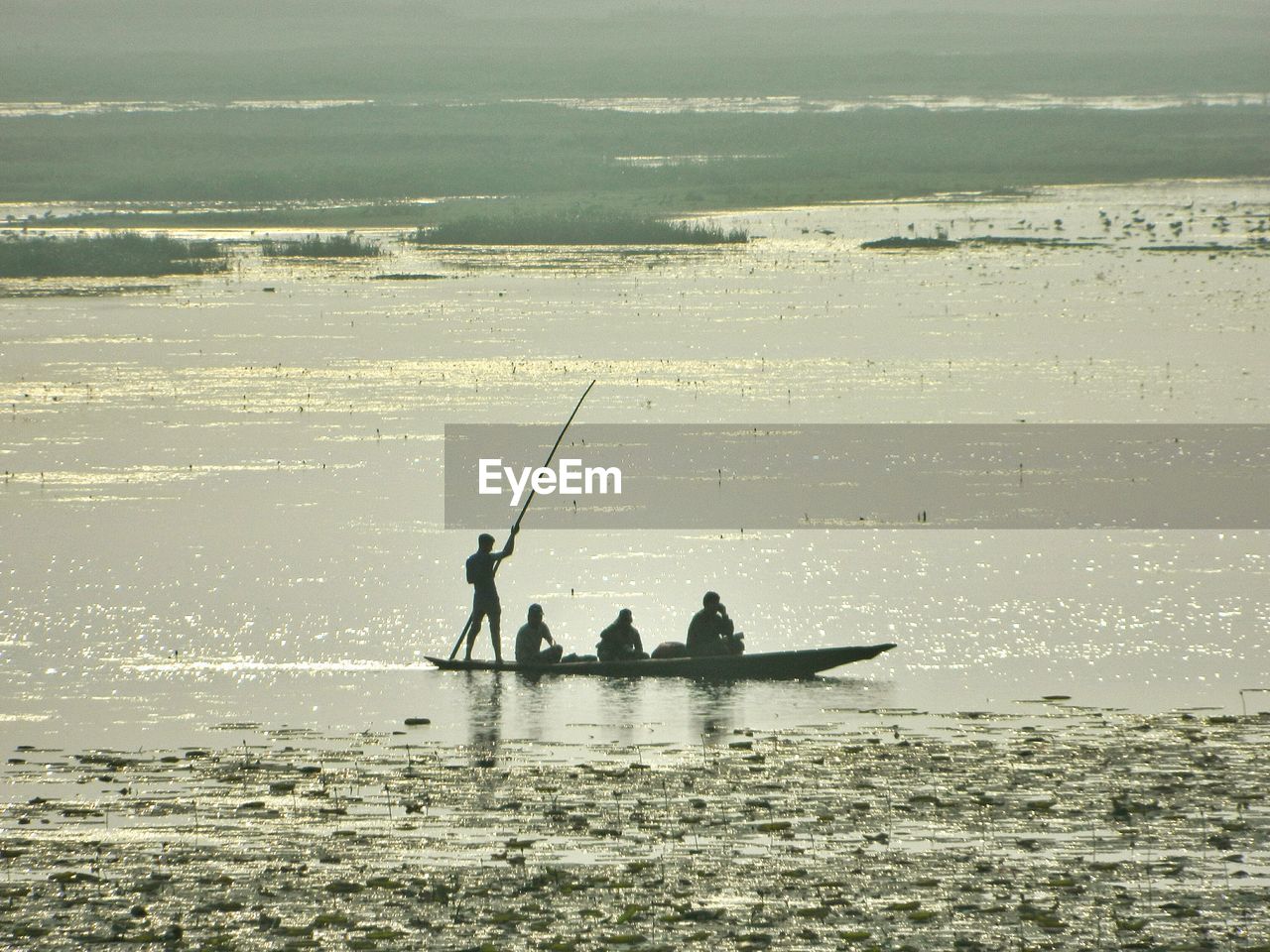 People in boat on lake