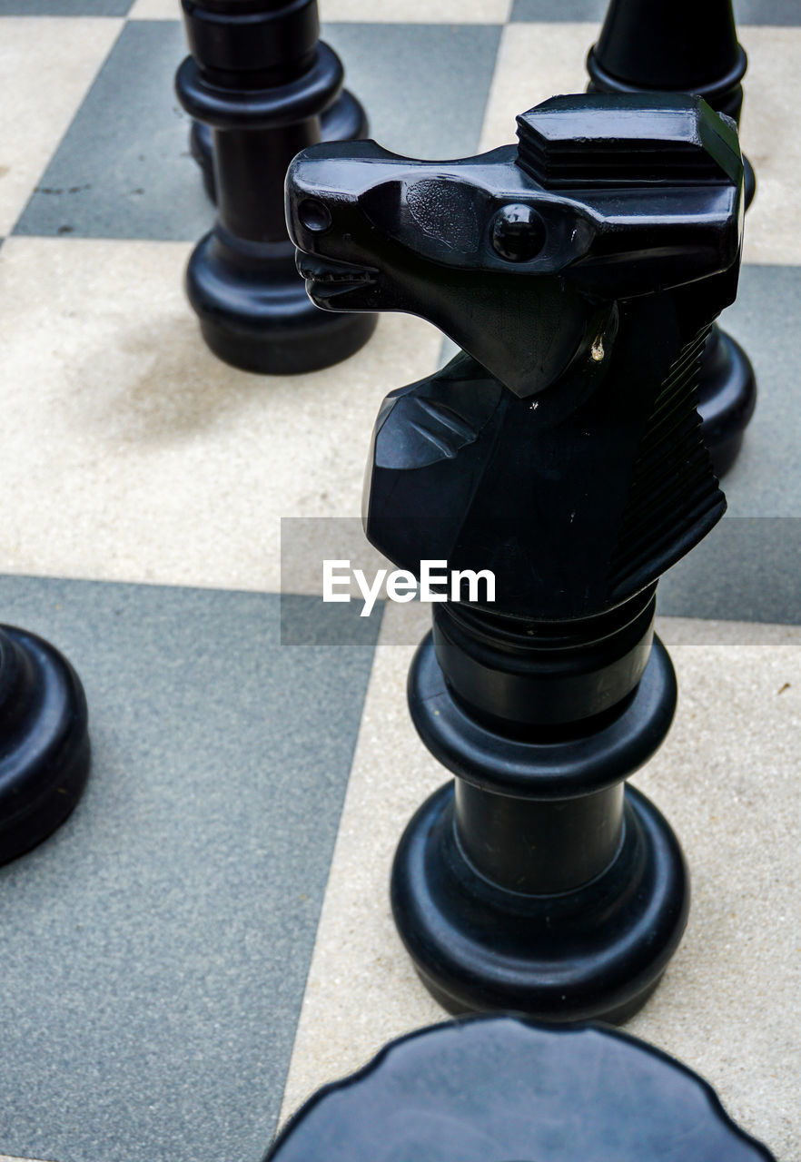 HIGH ANGLE VIEW OF CHESS PIECES ON FLOOR
