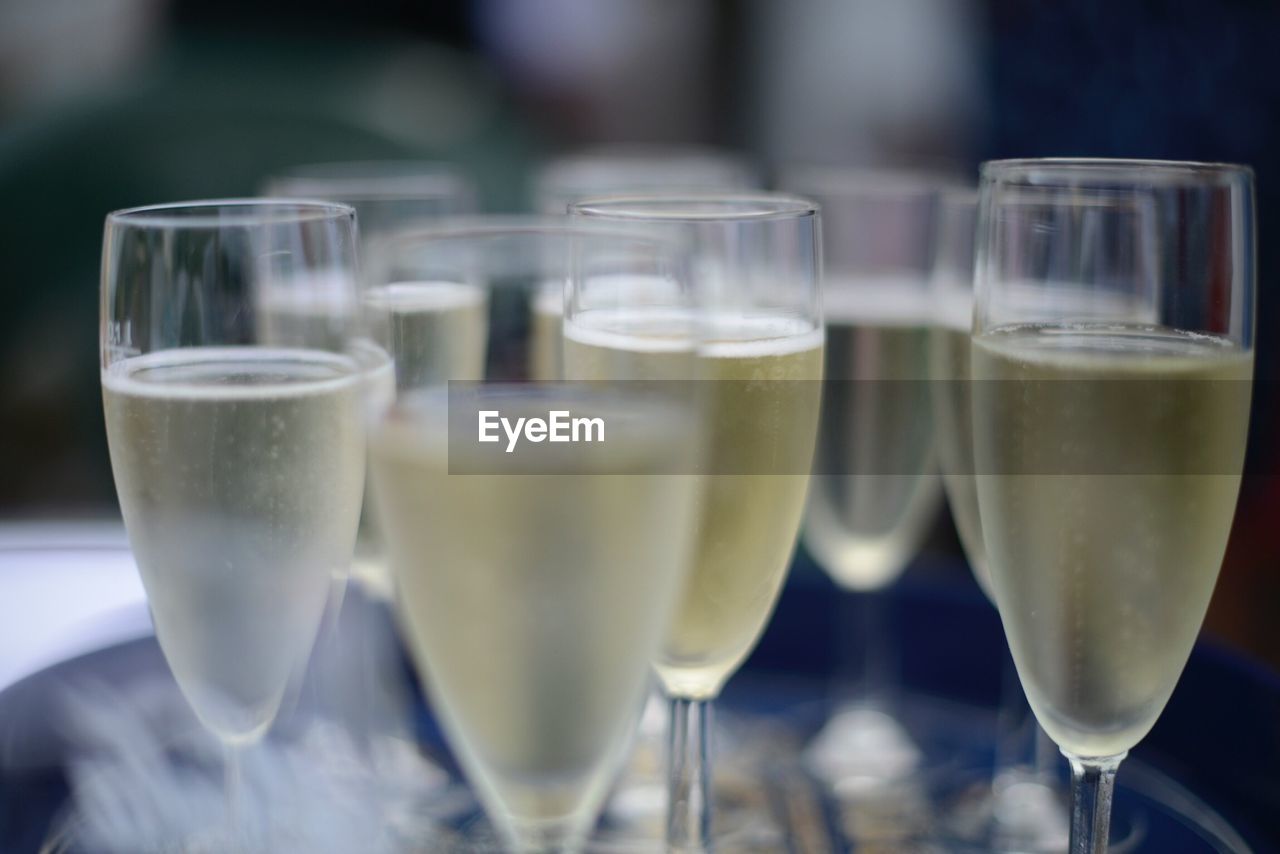 Close-up of champagne flutes against blurred background