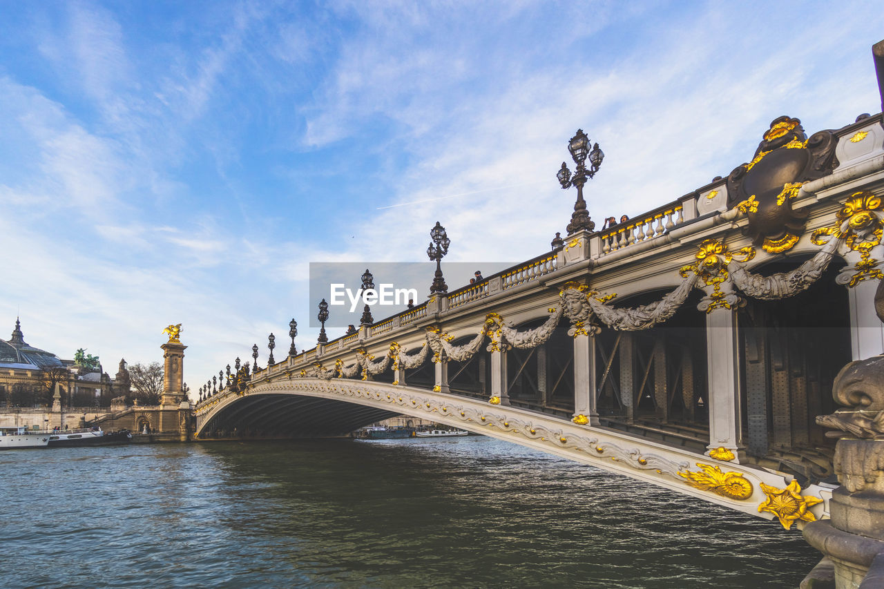 ARCH BRIDGE OVER RIVER AGAINST SKY