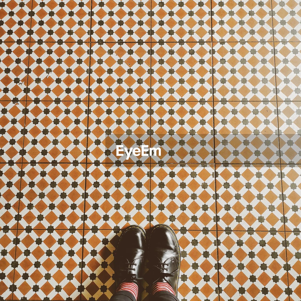 Low section of girl standing on tiled floor