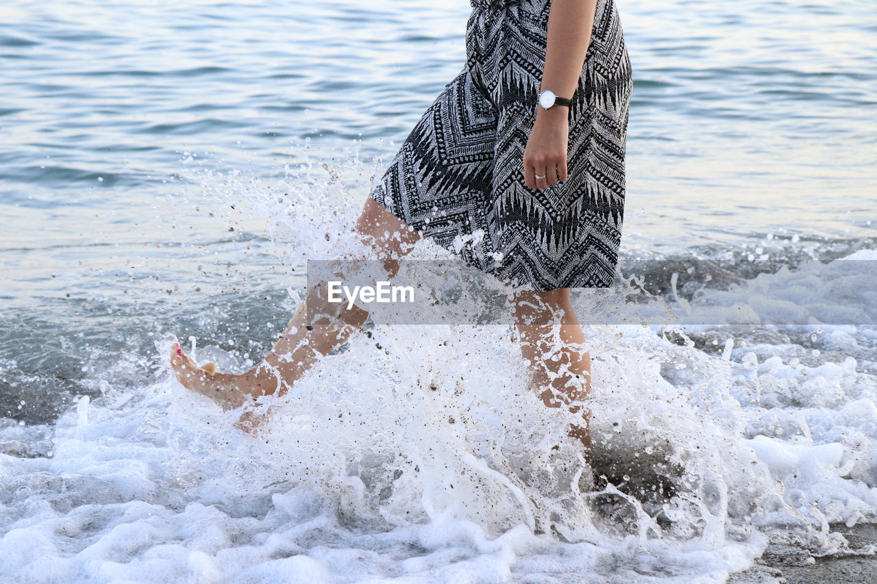 Low section of woman at beach 