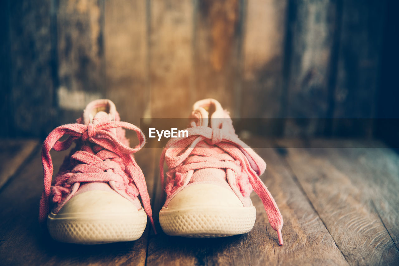 Close-up of shoes on wooden table