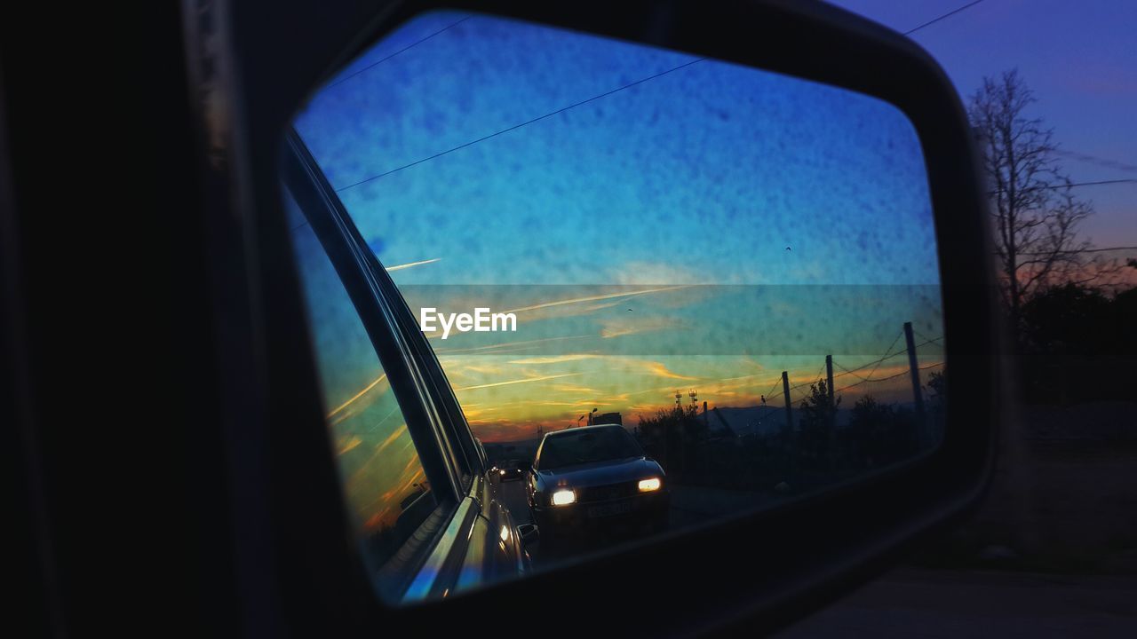 VIEW OF ROAD SEEN THROUGH TRAIN WINDOW