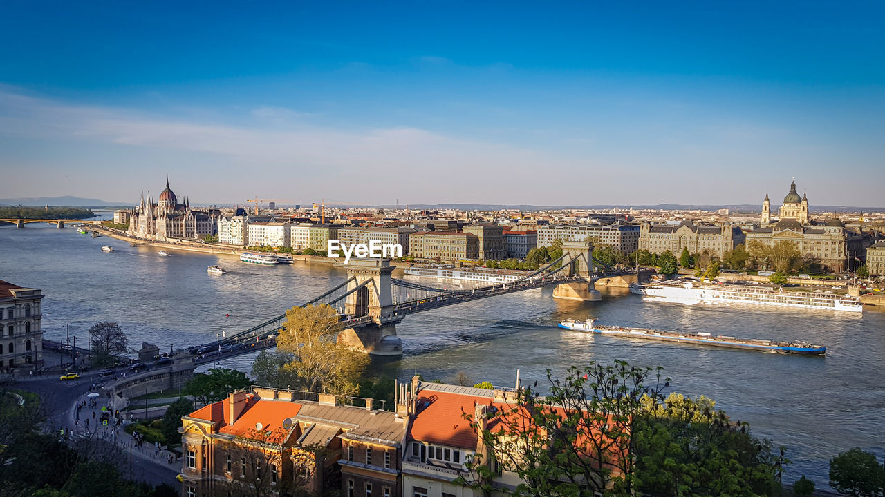 High angle view of bridge over river amidst buildings in city