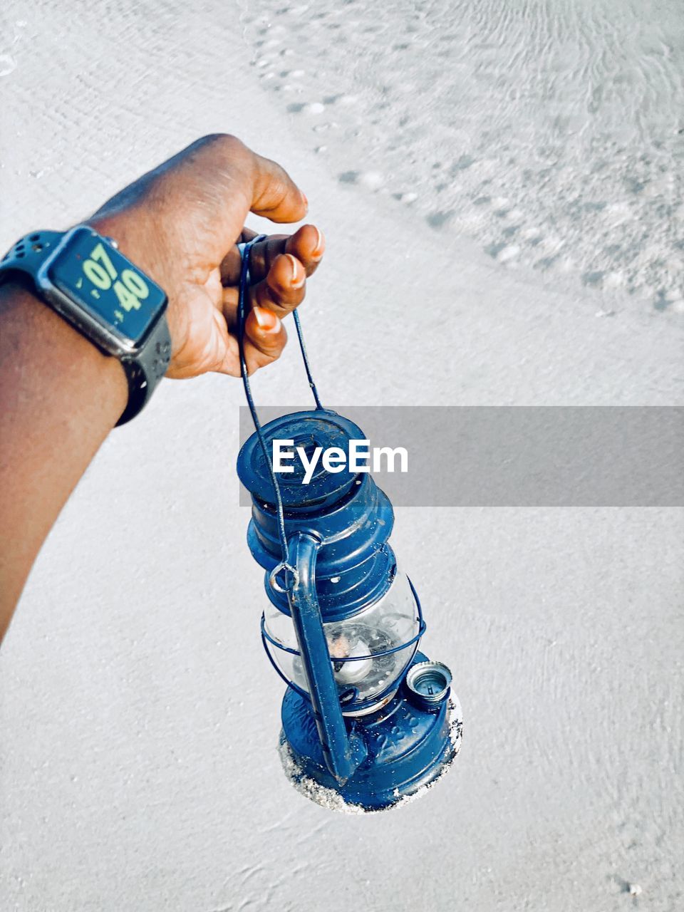 cropped hand of woman drinking water