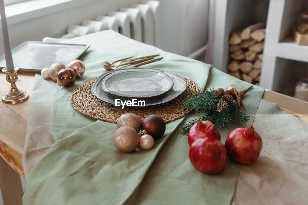 Serving a festive christmas table in scandinavian style. decor on the table before the holiday