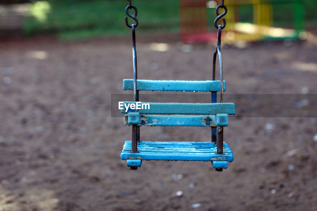 Empty baby swing hanging at playground