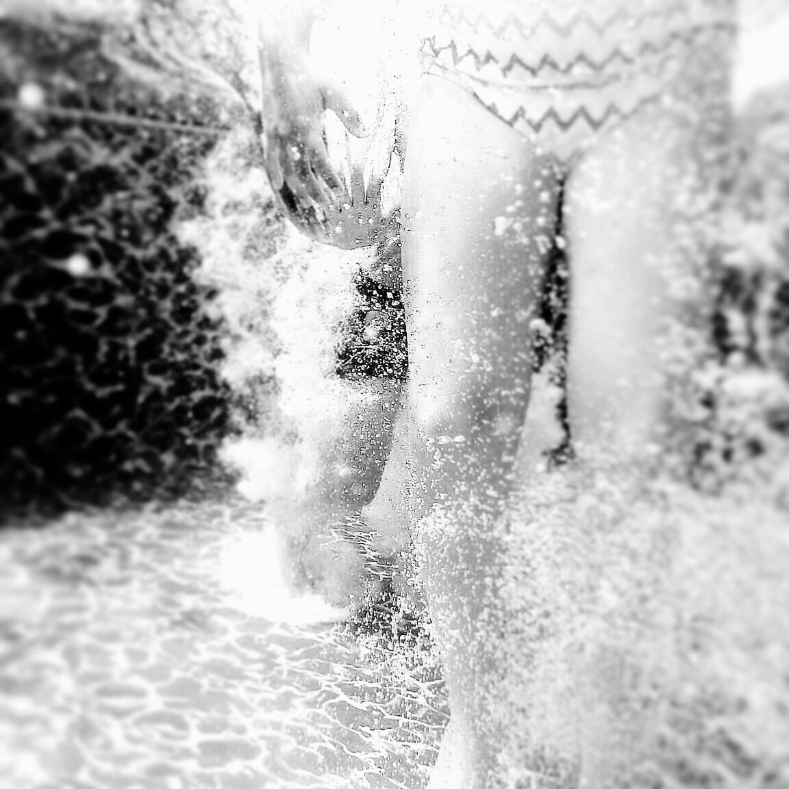 CLOSE-UP OF MAN SWIMMING IN POOL