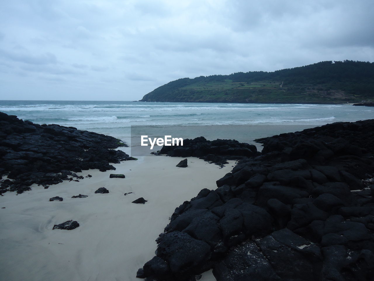 ROCKS ON SEA SHORE AGAINST SKY