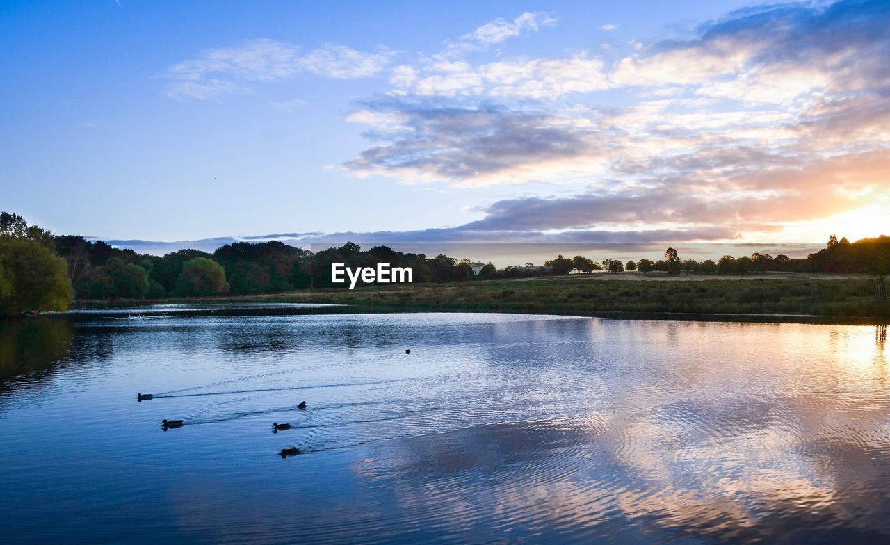 Scenic view of lake against sky during sunset