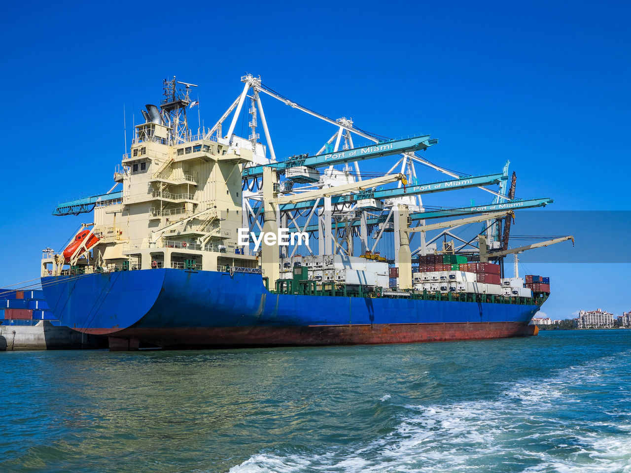 Port of miami cargo container ship with large cranes