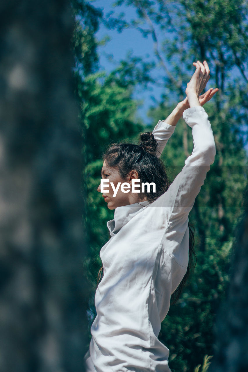 Woman dancing in forest