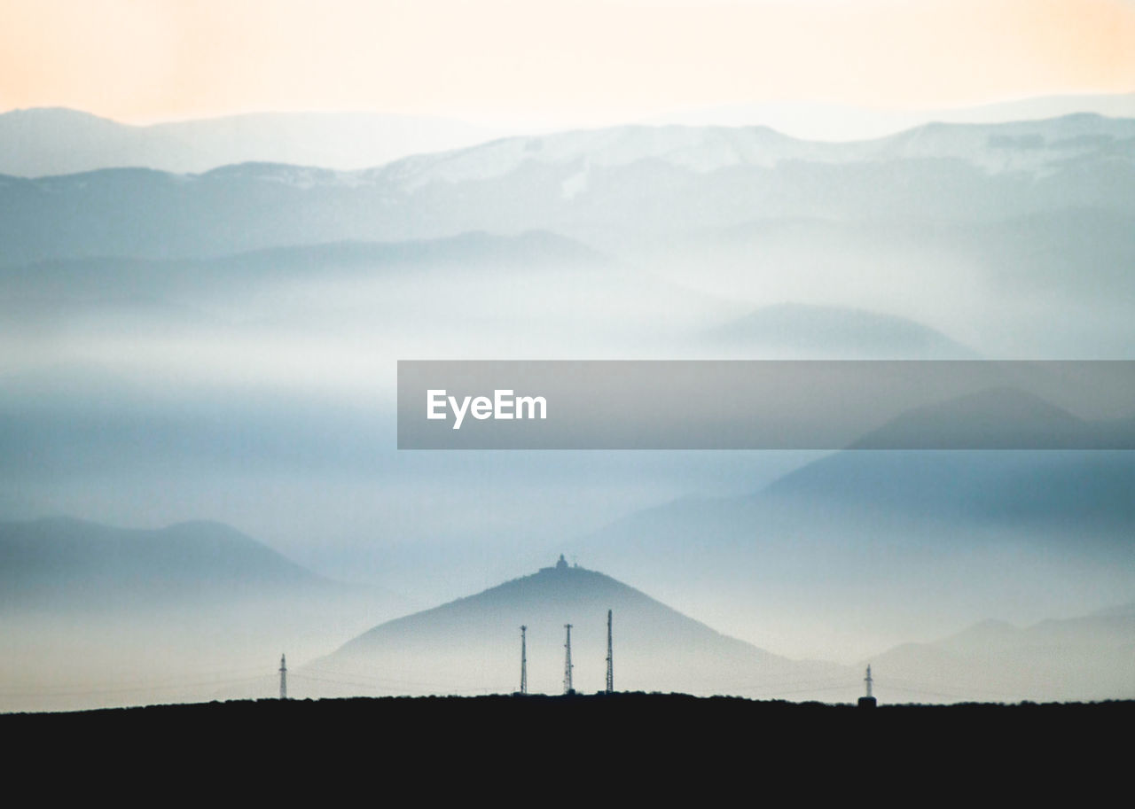 Scenic view of silhouette mountains against sky