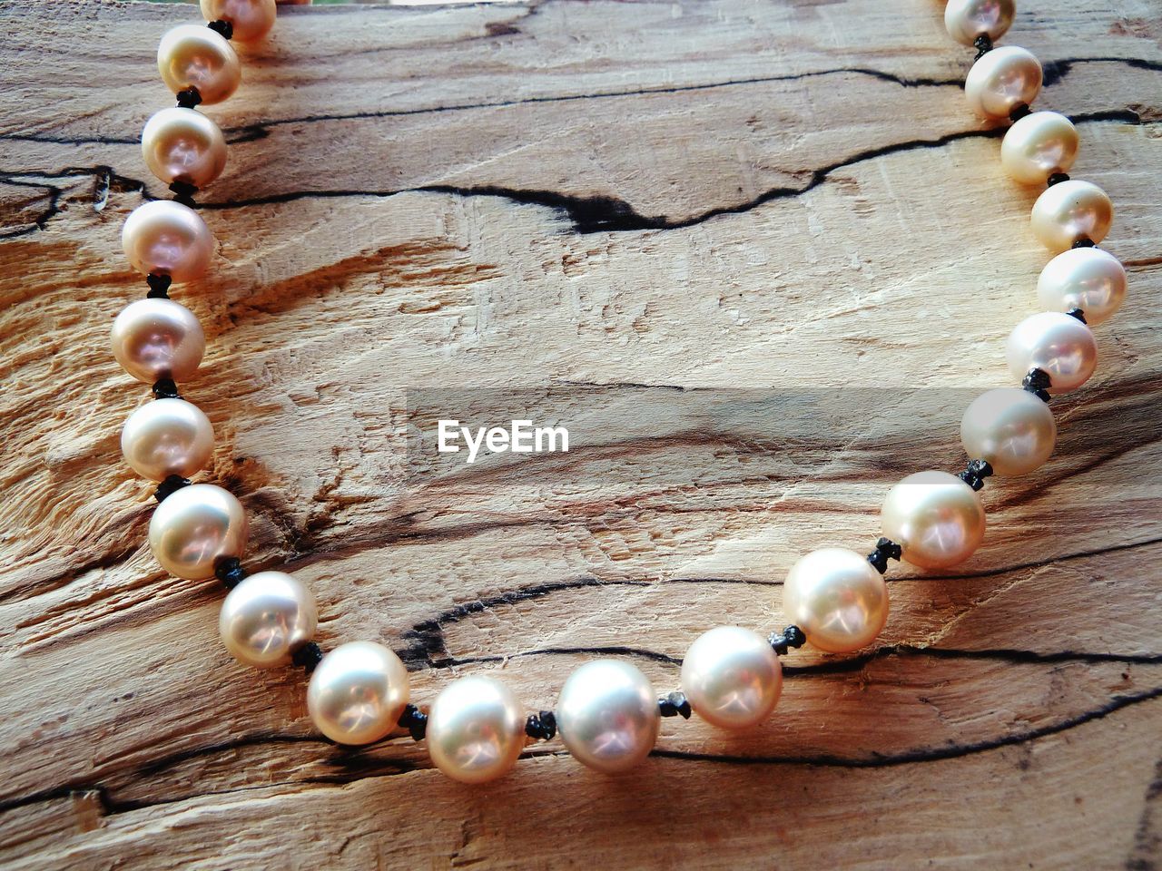 Close-up of pearl necklace on table